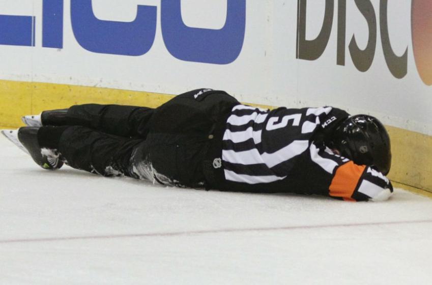 NHL referee stays in playoff game despite painful injury 